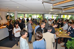 Personen beim Essen und im Gespräch im Foyer der ORCA Software GmbH.